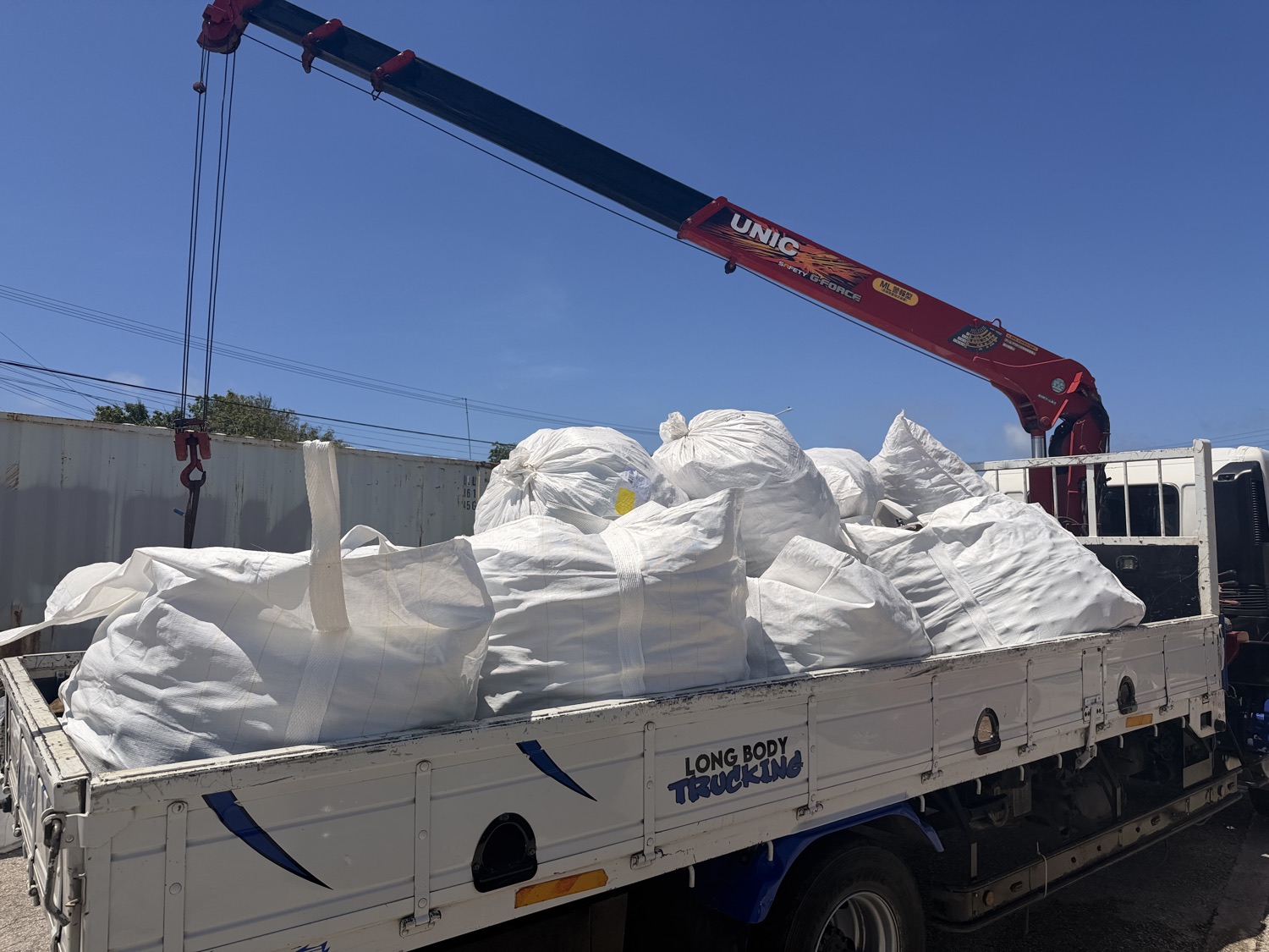 Full big bags are collected by crane truck